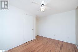 Empty room featuring ceiling fan, light wood-type flooring, and a textured ceiling - 