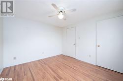 Unfurnished room with ceiling fan, a textured ceiling, and light hardwood / wood-style flooring - 