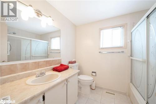 Full bathroom featuring vanity, backsplash, bath / shower combo with glass door, tile patterned flooring, and toilet - 15 Oakington Place, Mississauga, ON - Indoor Photo Showing Bathroom