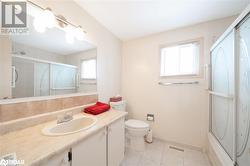 Full bathroom featuring vanity, backsplash, bath / shower combo with glass door, tile patterned flooring, and toilet - 