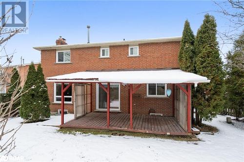 Snow covered rear of property featuring a wooden deck - 15 Oakington Place, Mississauga, ON - Outdoor With Exterior