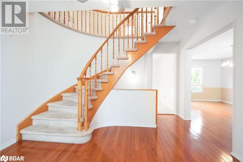 Stairs featuring hardwood / wood-style flooring and an inviting chandelier - 15 Oakington Place, Mississauga, ON - Indoor Photo Showing Other Room