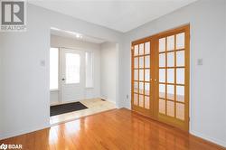 Entrance foyer with french doors and light wood-type flooring - 