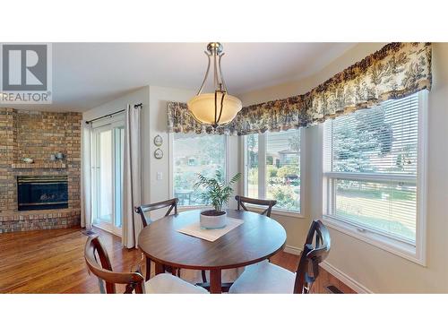 595 Yates Road Unit# 96 Lot# 60, Kelowna, BC - Indoor Photo Showing Dining Room With Fireplace