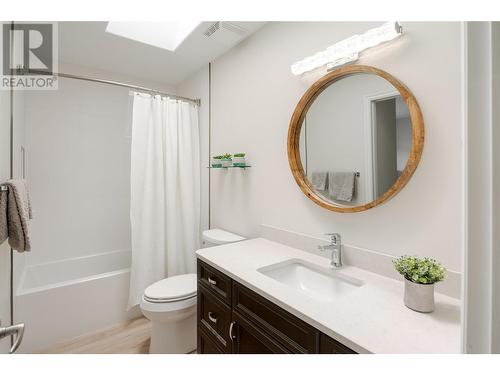 New mirror and lighting, refinished vanity, with quartz countertop and undermount sink - 2365 Stillingfleet Road Unit# 360, Kelowna, BC - Indoor Photo Showing Bathroom