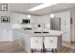 Updated kitchen including quartz countertops, shelving, appliances & more - 