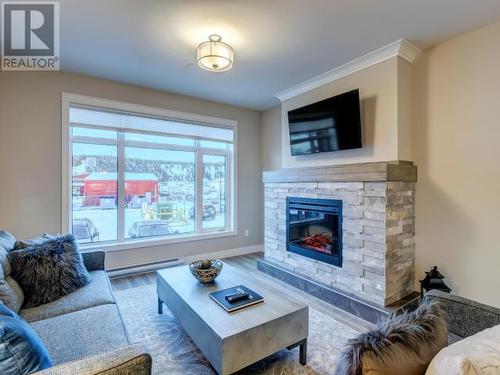 105-38 Waterfront Place, Whitehorse, YT - Indoor Photo Showing Living Room With Fireplace