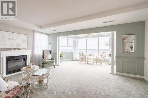 911 - 5280 Lakeshore Road, Burlington, ON - Indoor Photo Showing Living Room With Fireplace