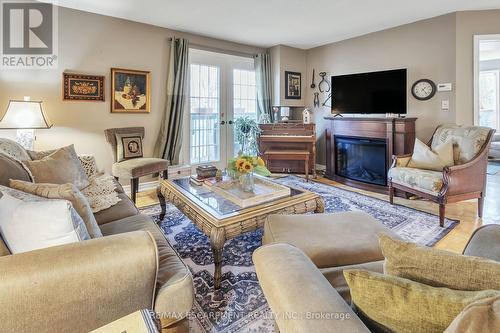 213 - 2030 Cleaver Avenue, Burlington, ON - Indoor Photo Showing Living Room With Fireplace