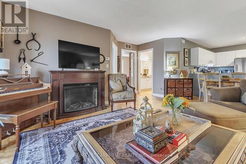 213 - 2030 Cleaver Avenue, Burlington, ON - Indoor Photo Showing Living Room With Fireplace