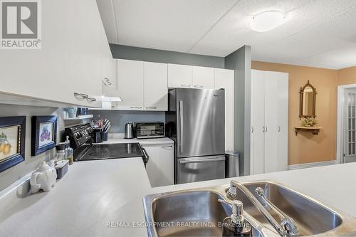 213 - 2030 Cleaver Avenue, Burlington, ON - Indoor Photo Showing Kitchen With Double Sink