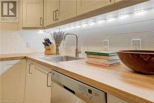 Kitchen featuring wooden counters, tasteful backsplash, sink, cream cabinetry, and dishwasher - 209 Cornwall Street, Waterloo, ON - Indoor Photo Showing Kitchen