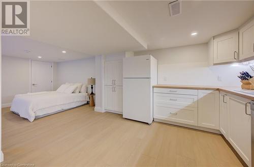 Bedroom with white refrigerator and light hardwood / wood-style floors - 209 Cornwall Street, Waterloo, ON - Indoor Photo Showing Bedroom