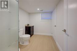 Bathroom featuring vanity, toilet, and wood-type flooring - 