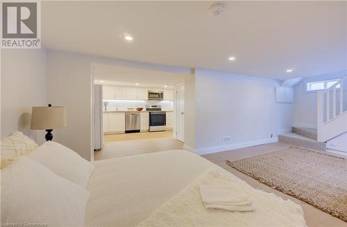 Bedroom featuring light hardwood / wood-style floors and white refrigerator - 209 Cornwall Street, Waterloo, ON - Indoor Photo Showing Bedroom