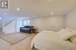 Bedroom with light hardwood / wood-style flooring - 