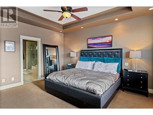 tray ceiling and fan in Primary - 1347 Wilmot Avenue, Kelowna, BC - Indoor Photo Showing Bedroom