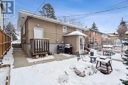 Rear yard showing entries to main floor and lower suites - 