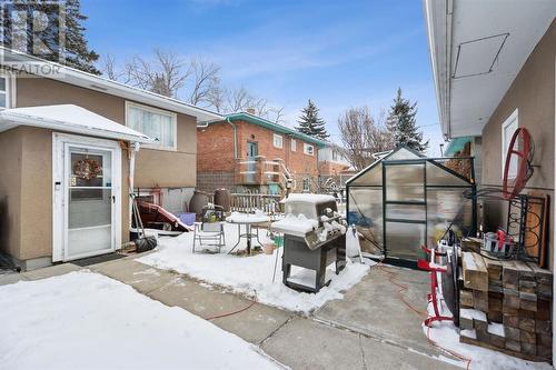 Rear yard showing garden area and garage at right - 1511 Child Avenue Ne, Calgary, AB - Outdoor With Exterior