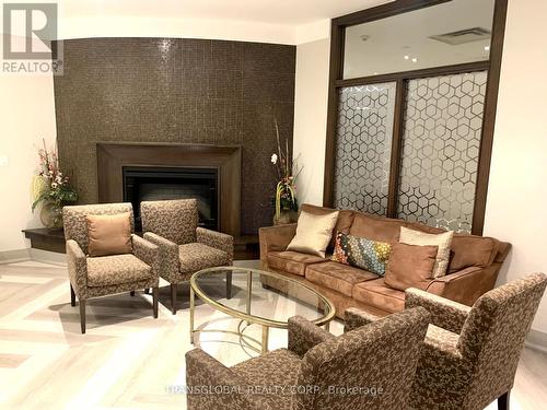 107 - 3840 Bathurst Street W, Toronto, ON - Indoor Photo Showing Living Room With Fireplace