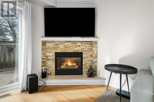 133 - 3333 New Street, Burlington, ON - Indoor Photo Showing Living Room With Fireplace