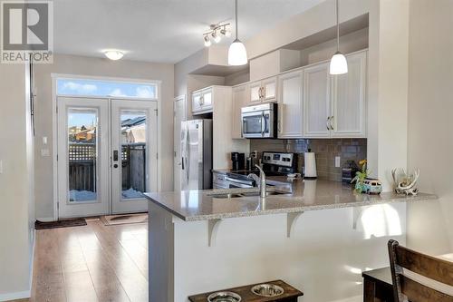 100 Legacy Main Street Se, Calgary, AB - Indoor Photo Showing Kitchen With Double Sink With Upgraded Kitchen