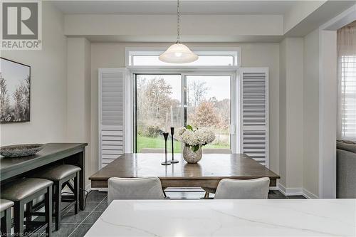 Dining area with dark tile patterned flooring - 116 Whithorn Crescent, Caledonia, ON - Indoor Photo Showing Dining Room