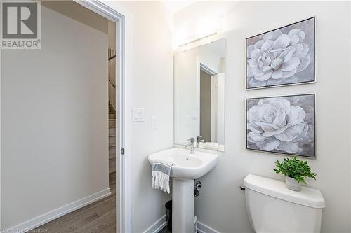 Bathroom featuring hardwood / wood-style flooring and toilet - 116 Whithorn Crescent, Caledonia, ON - Indoor Photo Showing Bathroom