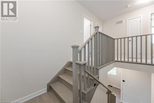 Stairway with hardwood / wood-style flooring - 116 Whithorn Crescent, Caledonia, ON - Indoor Photo Showing Other Room