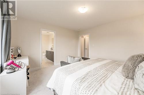 Bedroom with ensuite bathroom and light carpet - 116 Whithorn Crescent, Caledonia, ON - Indoor Photo Showing Bedroom