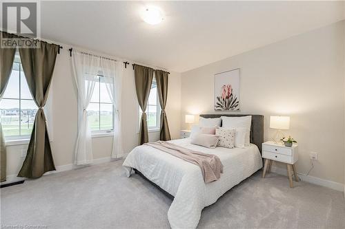 Carpeted bedroom with multiple windows - 116 Whithorn Crescent, Caledonia, ON - Indoor Photo Showing Bedroom