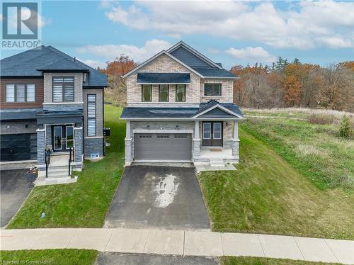 View of front of house with a garage and a front yard - 116 Whithorn Crescent, Caledonia, ON - Outdoor With Facade