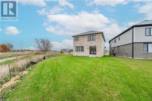 Back of property featuring a lawn and central AC - 116 Whithorn Crescent, Caledonia, ON - Outdoor