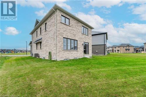 Back of house featuring cooling unit and a yard - 116 Whithorn Crescent, Caledonia, ON - Outdoor