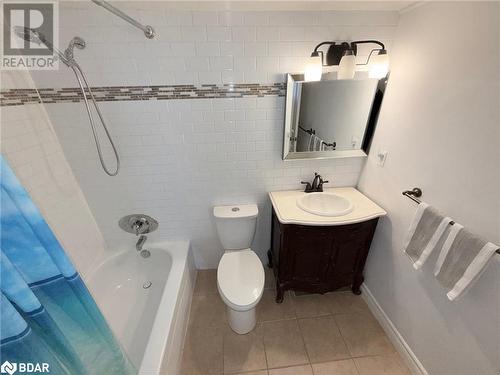 Full bathroom featuring toilet, vanity, tile patterned floors, and tiled shower / bath combo - 2263 Marine Drive Unit# 607, Oakville, ON 