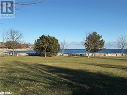 View of community with a yard and a water view - 