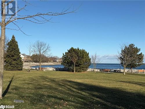 View of property's community featuring a lawn and a water view - 2263 Marine Drive Unit# 607, Oakville, ON 