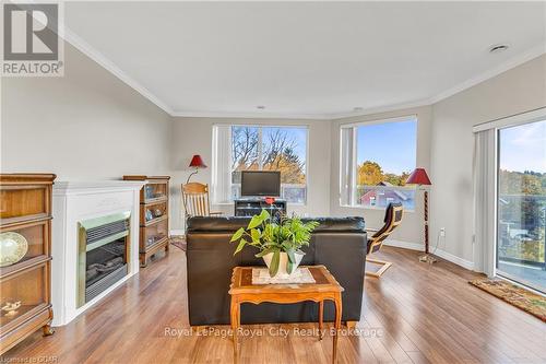 311 - 60 Wyndham Street S, Guelph (Two Rivers), ON - Indoor Photo Showing Living Room With Fireplace