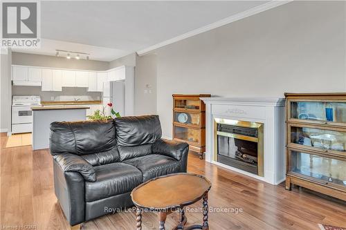 311 - 60 Wyndham Street S, Guelph (Two Rivers), ON - Indoor Photo Showing Living Room With Fireplace