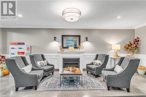 311 - 60 Wyndham Street S, Guelph (Two Rivers), ON - Indoor Photo Showing Living Room With Fireplace