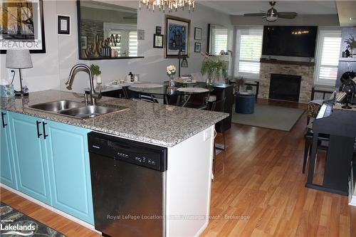 107 - 3 Brandy Lane Drive, Collingwood, ON - Indoor Photo Showing Kitchen With Fireplace With Double Sink