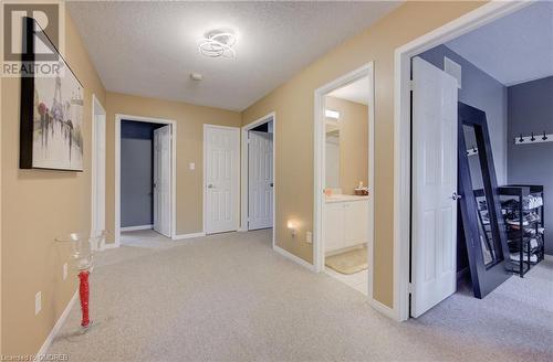 Hall featuring a textured ceiling and light carpet - 32 Triller Avenue, Cambridge, ON - Indoor Photo Showing Other Room