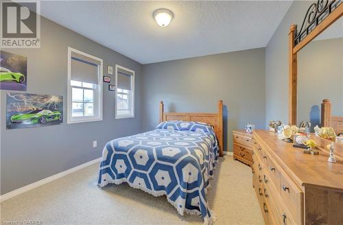 Carpeted bedroom with a textured ceiling - 32 Triller Avenue, Cambridge, ON - Indoor Photo Showing Bedroom