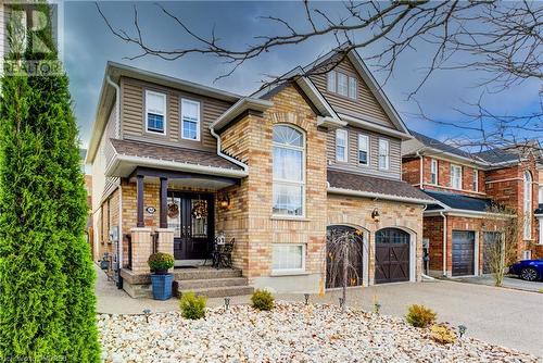 View of front of home with a garage and a porch - 32 Triller Avenue, Cambridge, ON - Outdoor With Facade