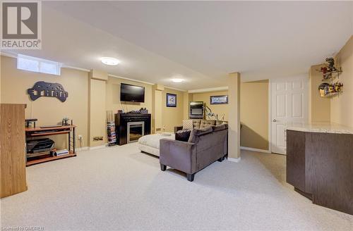 View of carpeted living room - 32 Triller Avenue, Cambridge, ON - Indoor Photo Showing Basement With Fireplace