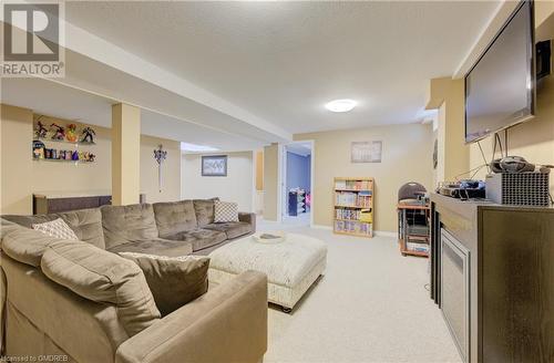 Living room with a textured ceiling and light colored carpet - 32 Triller Avenue, Cambridge, ON - Indoor