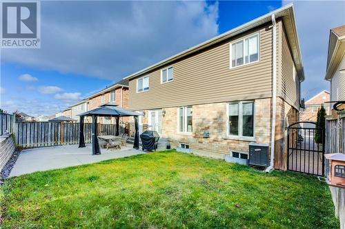 Back of house featuring a patio area, a yard, a gazebo, and cooling unit - 32 Triller Avenue, Cambridge, ON - Outdoor With Exterior