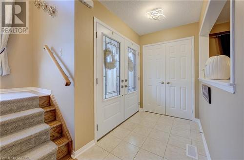 Entryway with a textured ceiling and light tile patterned floors - 32 Triller Avenue, Cambridge, ON - Indoor Photo Showing Other Room