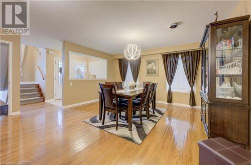 Dining area with light hardwood / wood-style flooring, a textured ceiling, and a chandelier - 32 Triller Avenue, Cambridge, ON - Indoor Photo Showing Dining Room