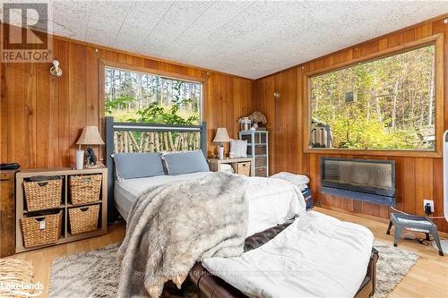 165 James Camp Road, Ryerson, ON - Indoor Photo Showing Bedroom With Fireplace